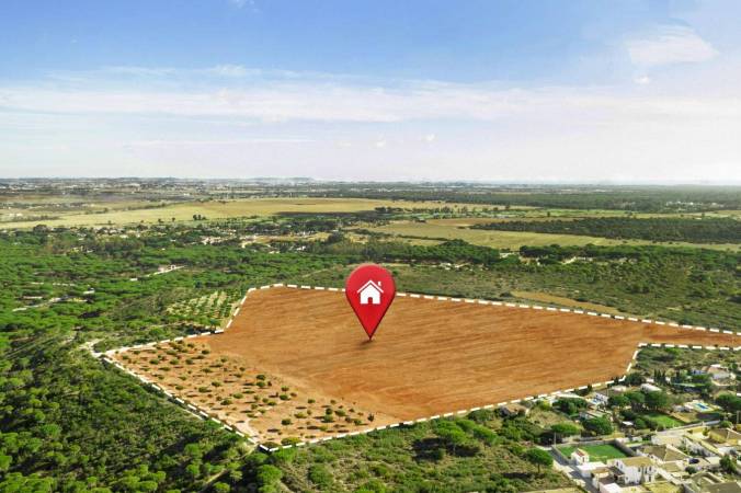 What factors should you consider when purchasing land to build a house?